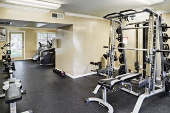 Fitness center with exercise equipment and mirrors